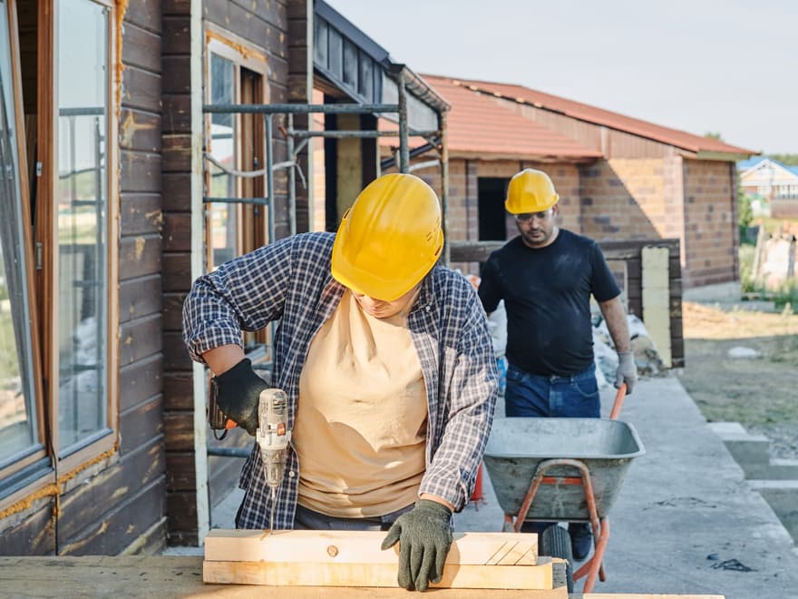 Builders working on the tools at a house site