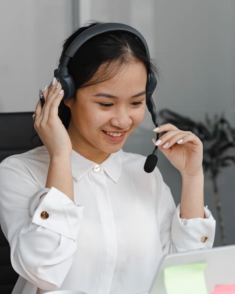 Smiling receptionist adjusting her headset